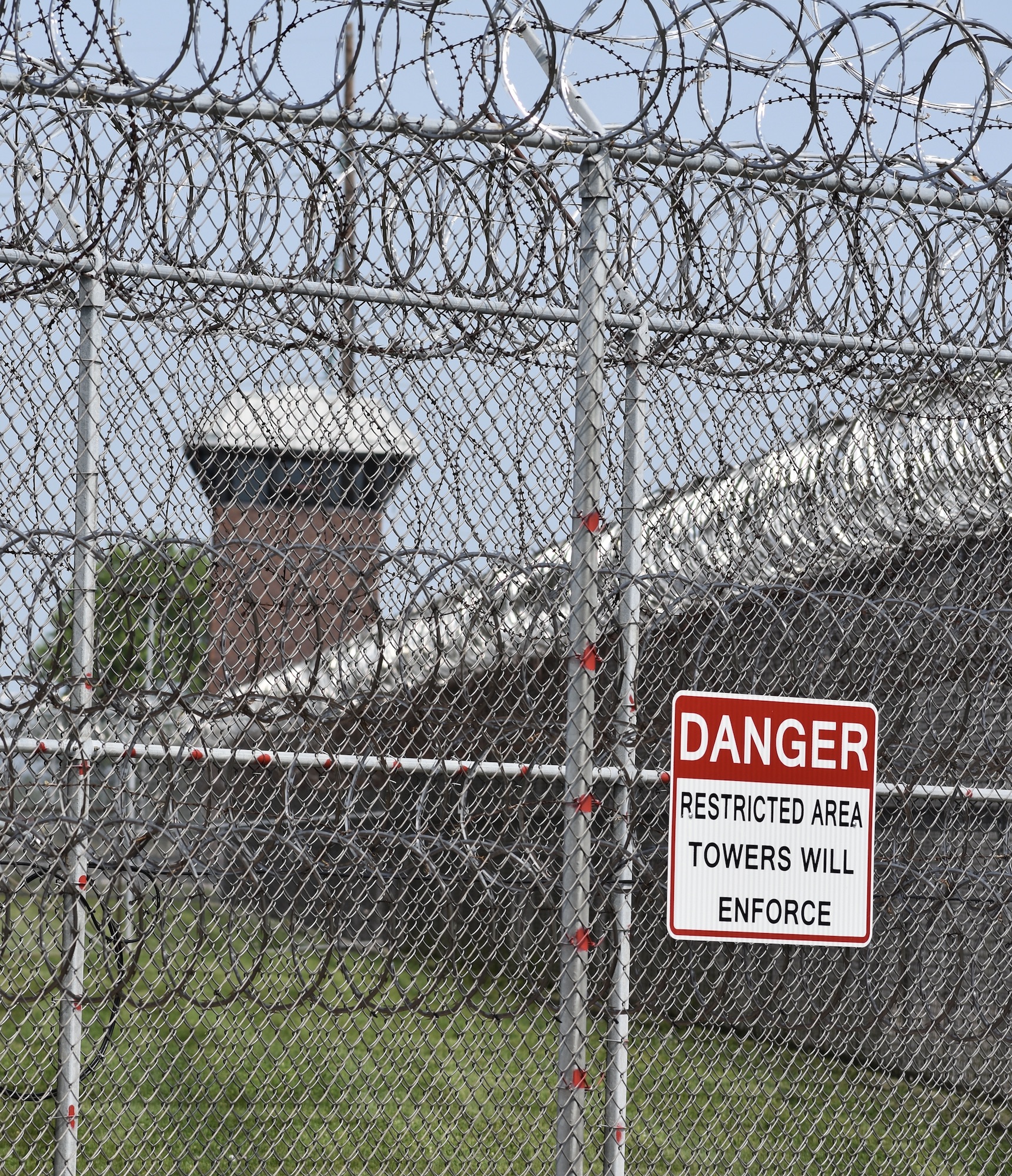 Concertina wire on a perimeter fence and a guard tower